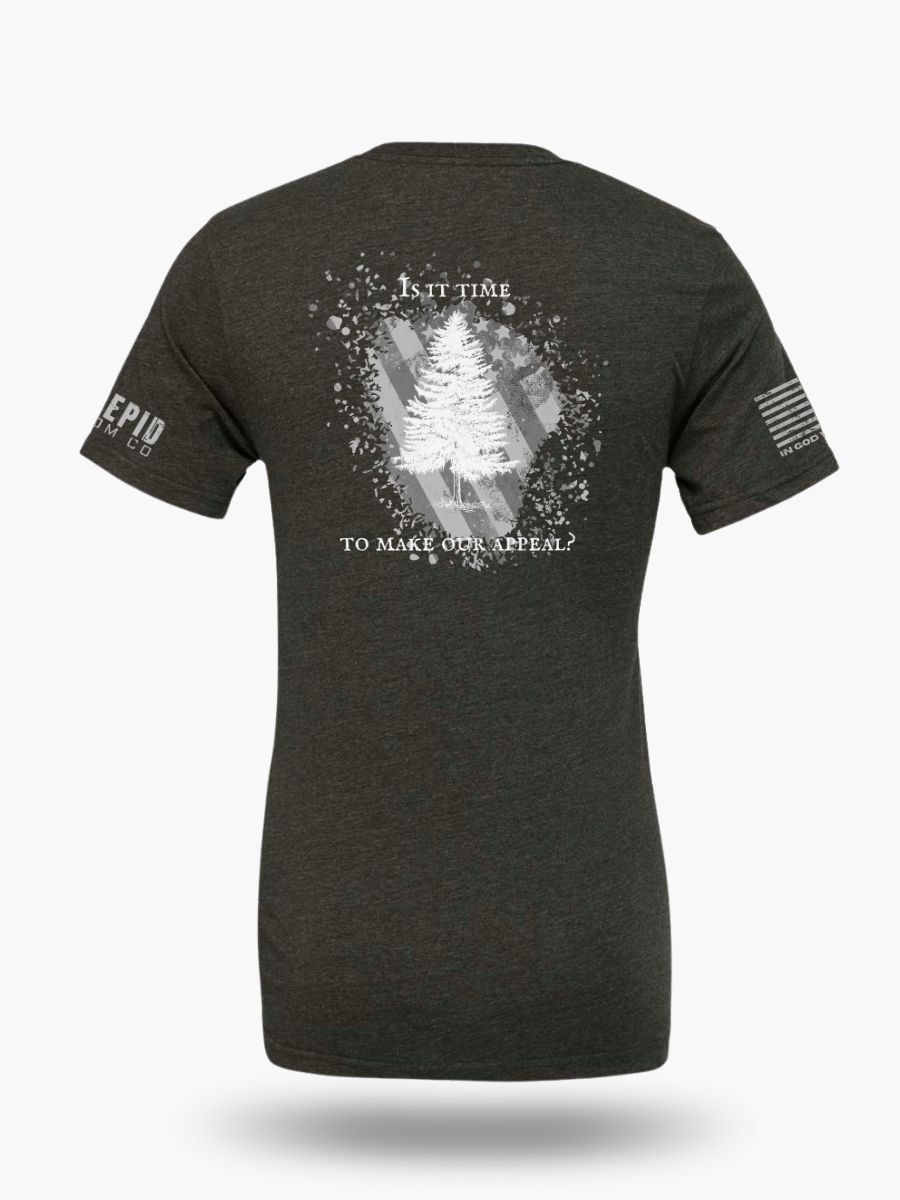 Dark heather grey t-shirt with Appeal to Heaven flag design featuring a bold White Pine Tree over a distressed American flag background. Historic patriotic graphic with strong revolutionary symbolism.
