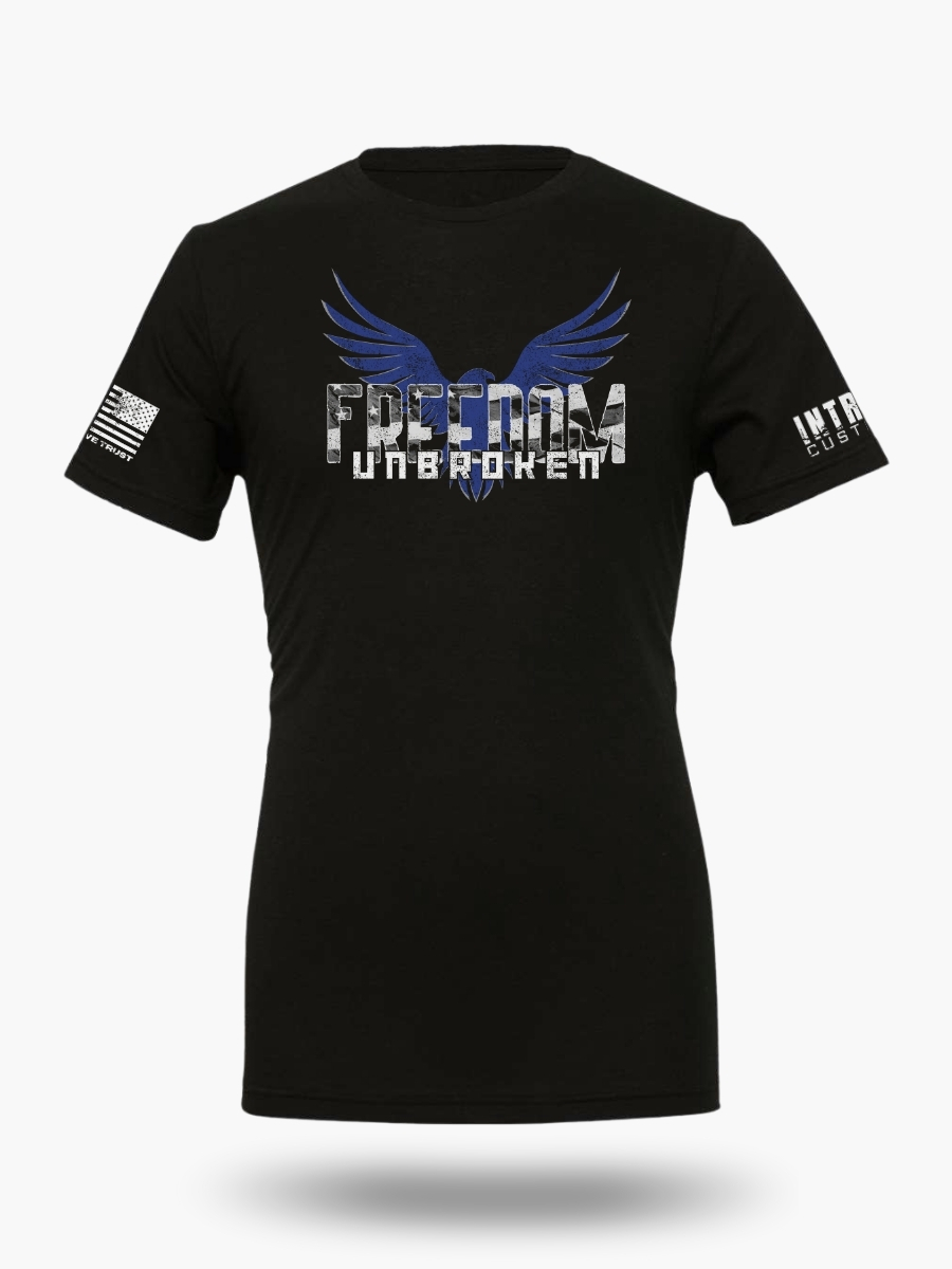 Black t-shirt featuring a bold eagle with outstretched wings and the text "FREEDOM UNBROKEN" in a distressed font, with an American flag patch on the sleeve.