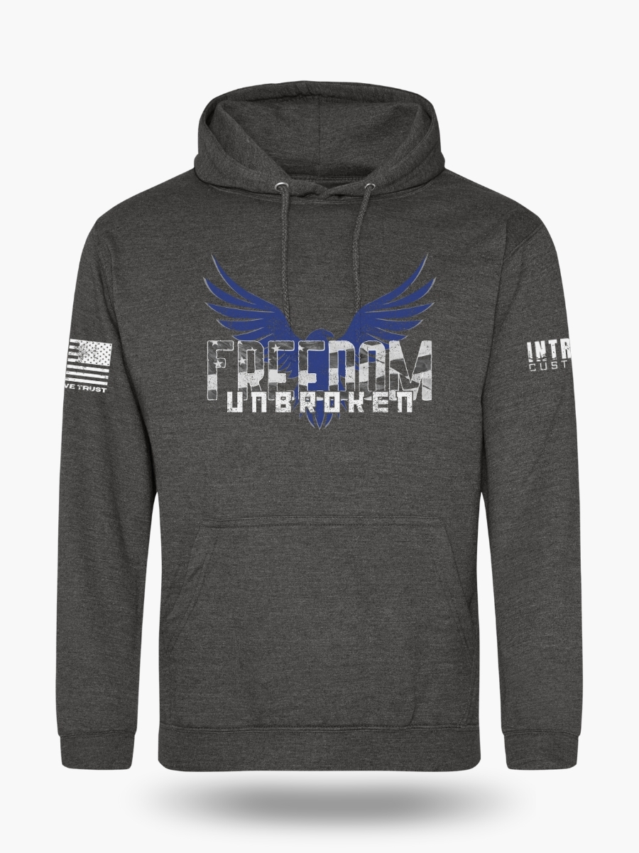Charcoal hoodie featuring a bold eagle with outstretched wings and the text "FREEDOM UNBROKEN" in a distressed font, with an American flag patch on the sleeve.