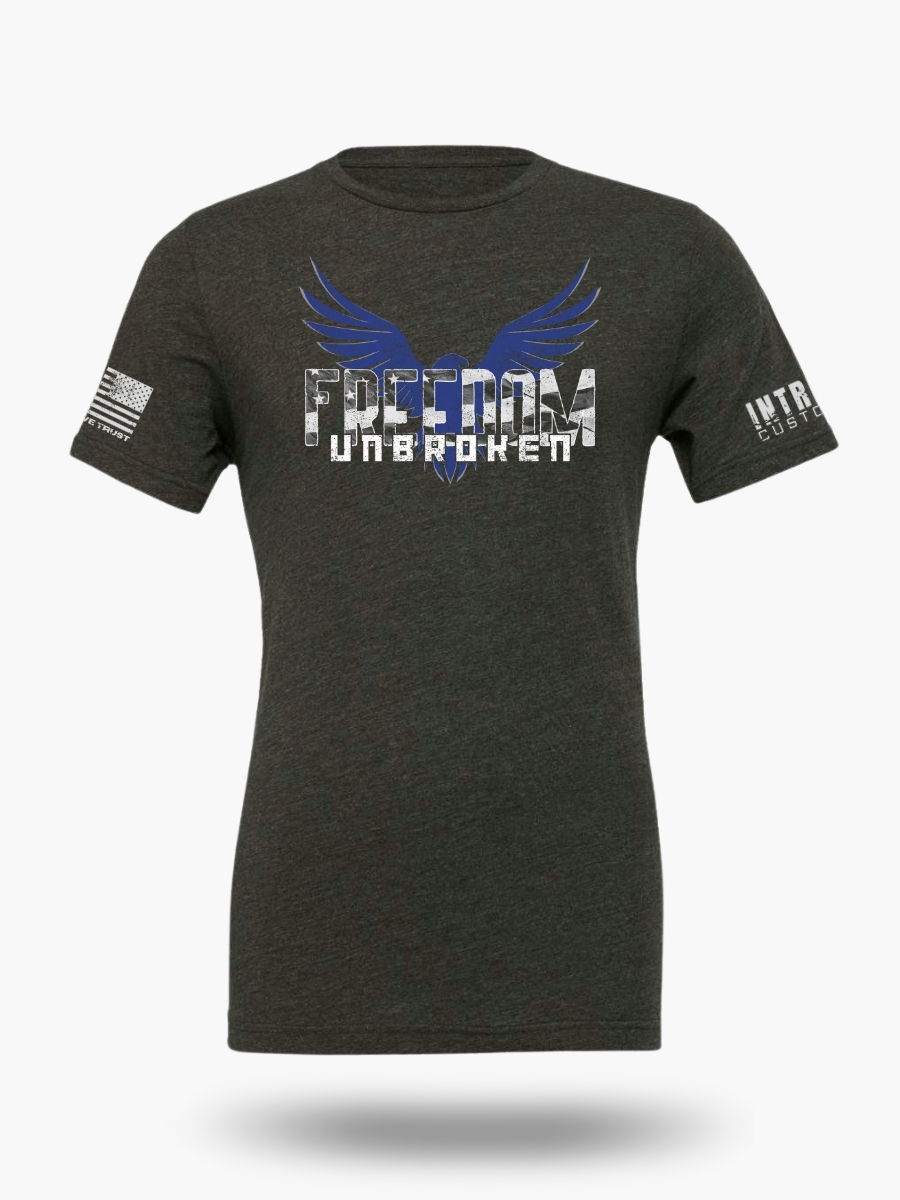 Dark Heather Grey t-shirt featuring a bold eagle with outstretched wings and the text "FREEDOM UNBROKEN" in a distressed font, with an American flag patch on the sleeve.