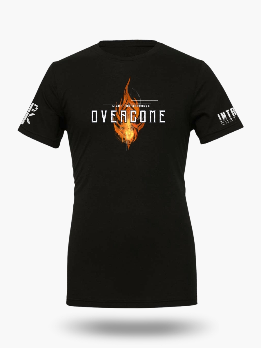 Black t-shirt with a vibrant orange flame design and the text "OVERCOME - LIGHT THE DARKNESS" in bold white font.