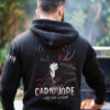 Man wearing black hoodie featuring a fierce deer skull graphic with the words &acirc;Carnivore &acirc; I Eat the Losers.&acirc; Warm, rugged hunting hoodie for outdoor enthusiasts.
