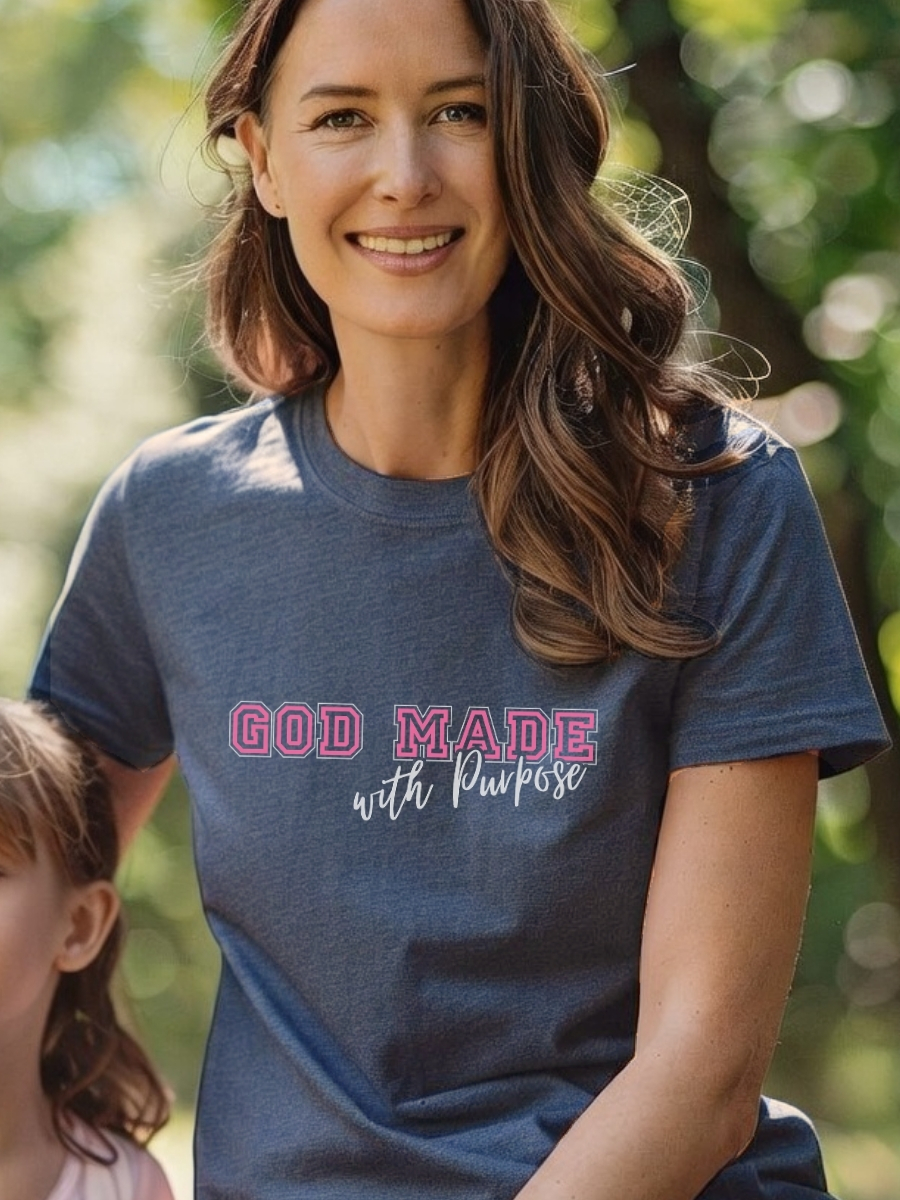 Elegant women&acirc;s Christian t-shirt features a beautiful ornate cross with 'We Are His Workmanship' in pink script and the full Ephesians 2:10 verse. Front design reads 'God Made With Purpose'. A graceful daily reminder of your identity in Christ. Color Heather Navy.